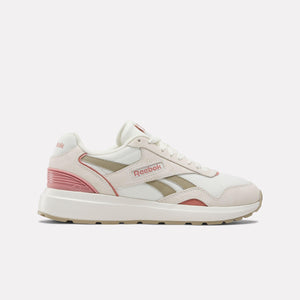 A low-top sneaker is white with pink and beige accents, featuring the text "Reebok".