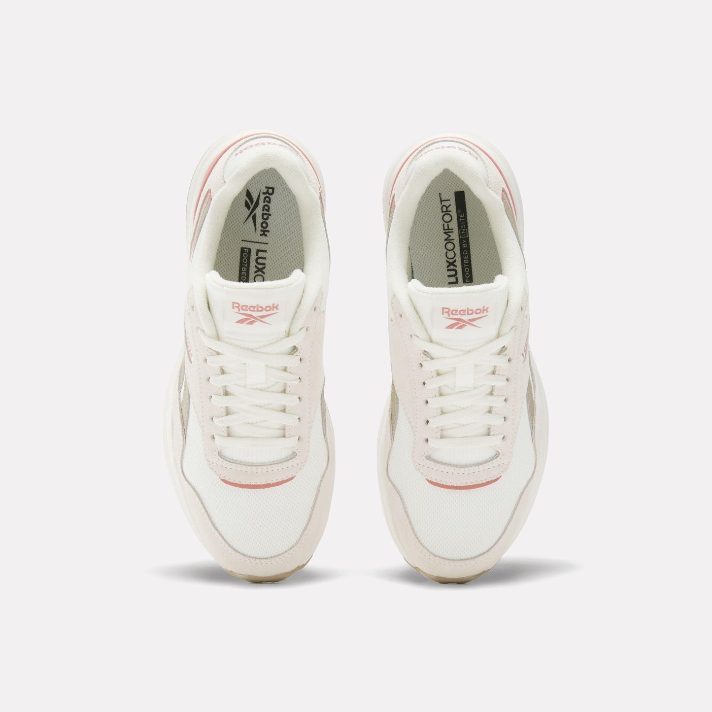 Pair of white shoes with 'LUX COMFORT' print inside.