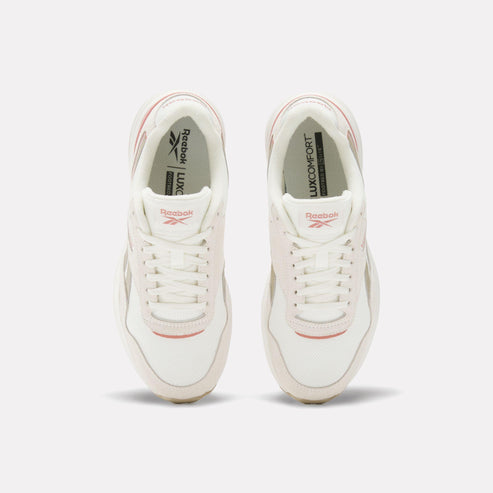 Pair of white shoes with 'LUX COMFORT' print inside.