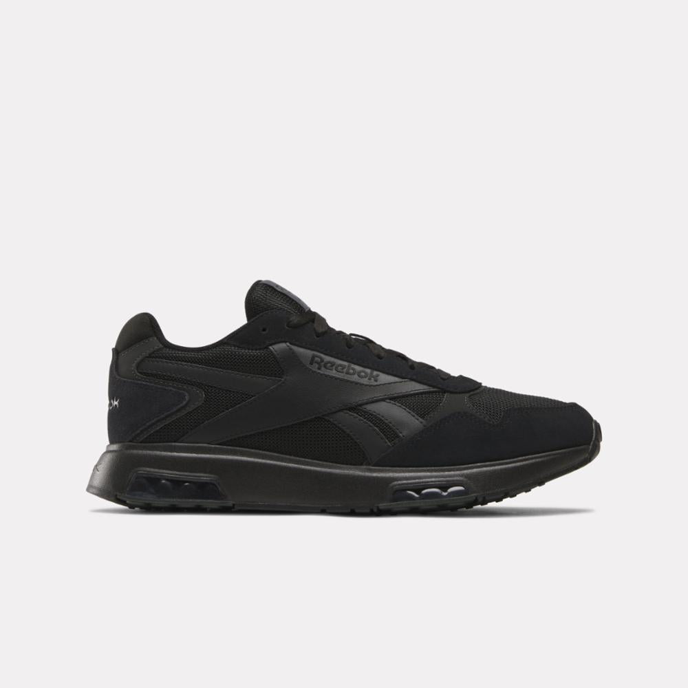 Black sneaker with the text Reebok in black on the side.