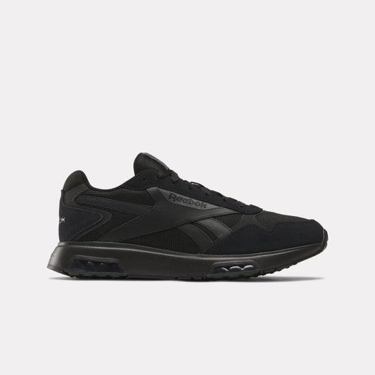 Black sneaker with the text Reebok in black on the side.