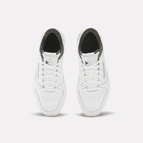 Two white Reebok sneakers, top view.