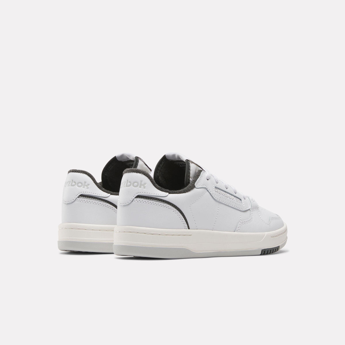 Low-top white sneakers with gray accent.