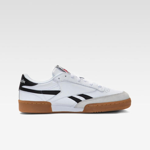 White shoe with black stripe and brown sole.