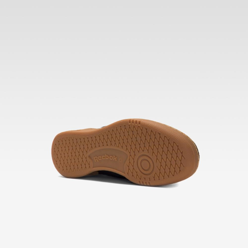 Angled close-up of a brown shoe sole with a honeycomb pattern.
