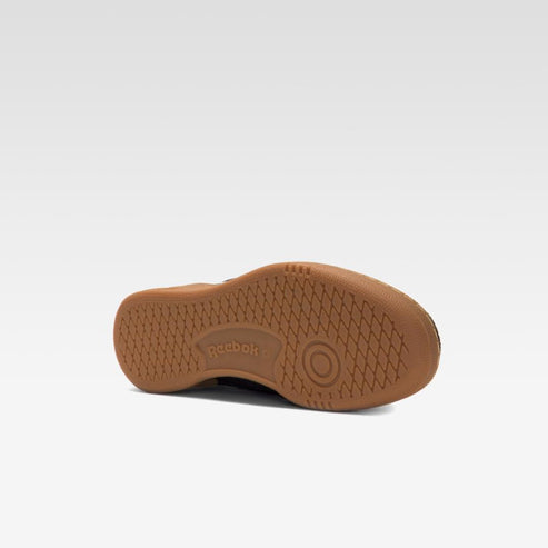 Angled close-up of a brown shoe sole with a honeycomb pattern.