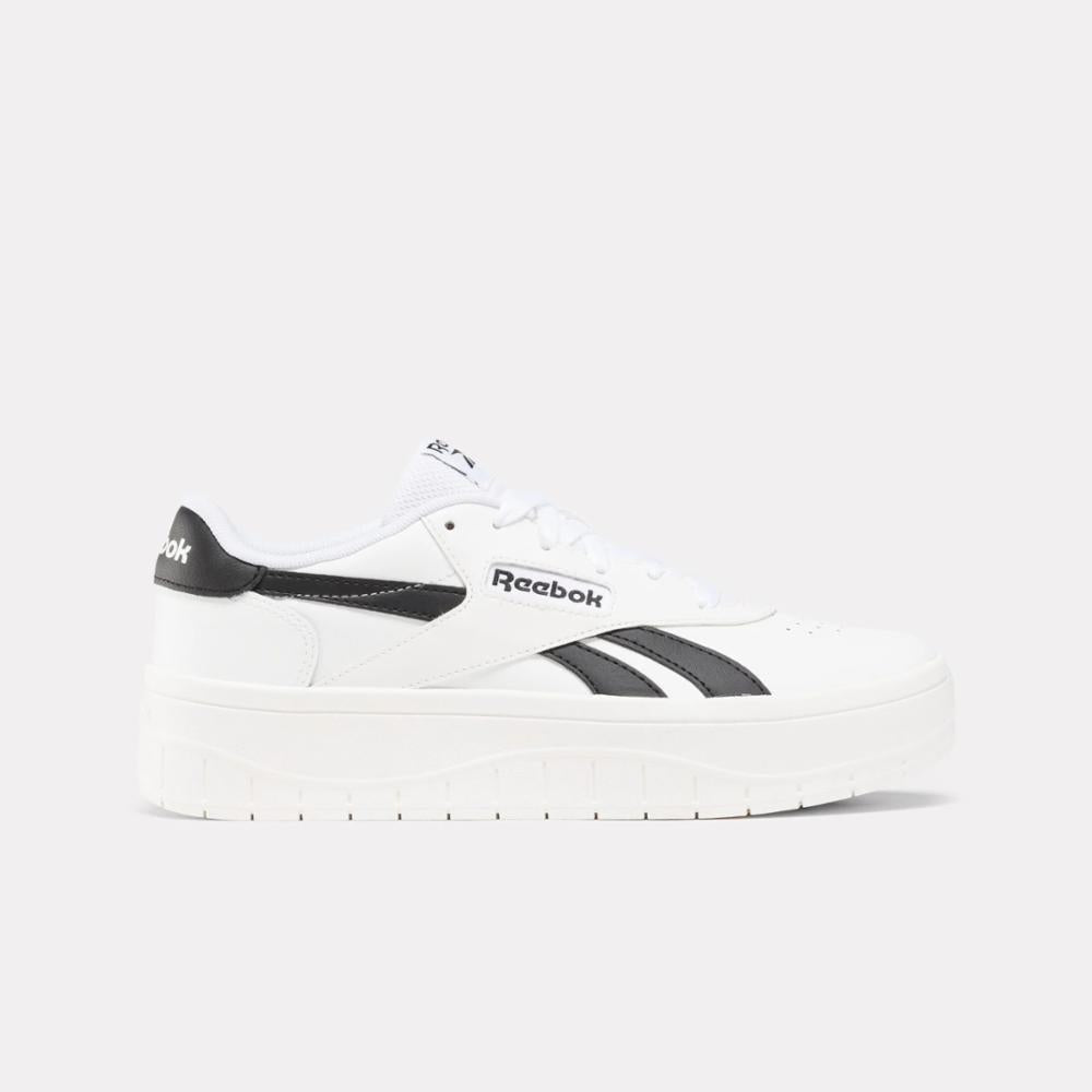 White low-top platform sneaker with black accents.