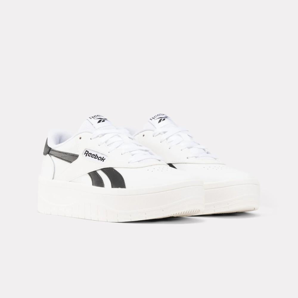 Low-top white sneaker with black stripes.