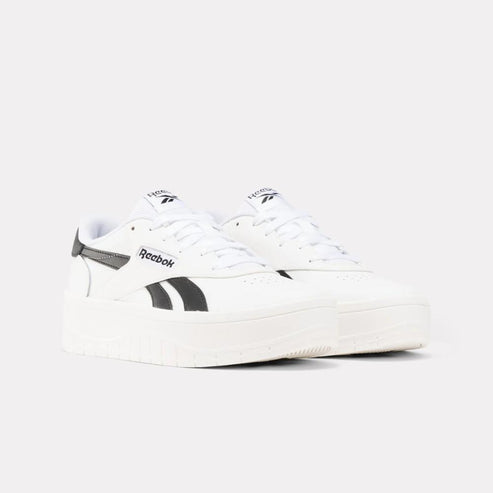 Low-top white sneaker with black stripes.