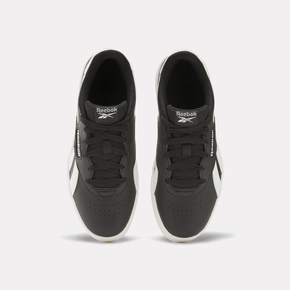 Overhead view of two black and white sneakers with laces.