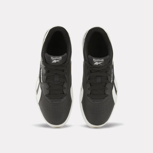 Overhead view of two black and white sneakers with laces.