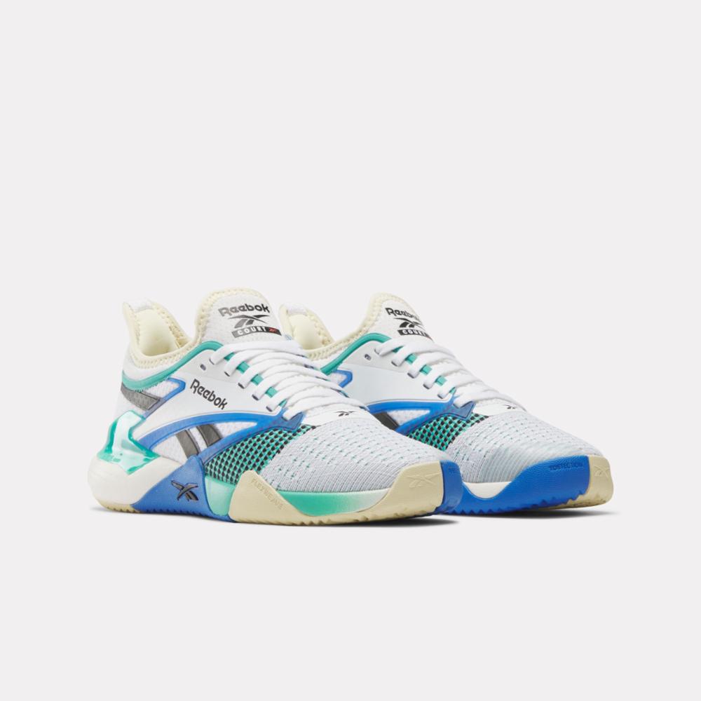 Pair of white athletic shoes with blue and green accents.