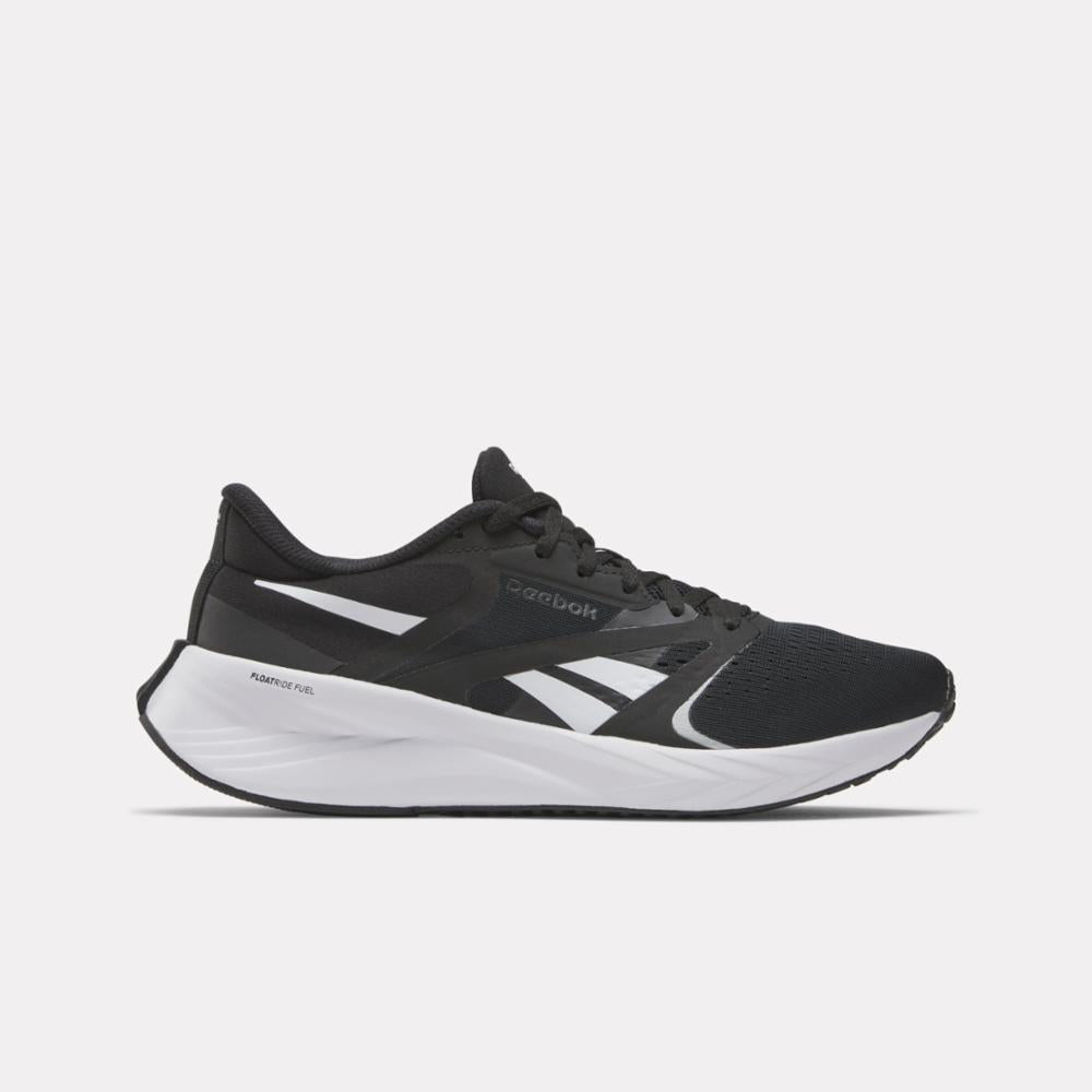 A black running shoe with white accents and a thick white sole.