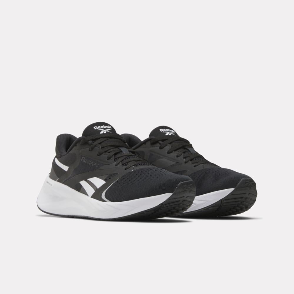 Pair of black and white running shoes with mesh upper and curved sole.