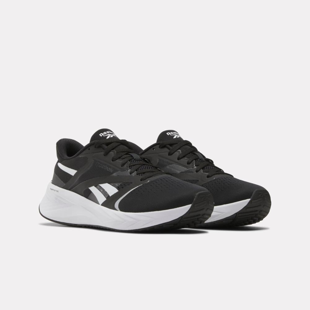 A pair of black running shoes with white stripes and white soles.