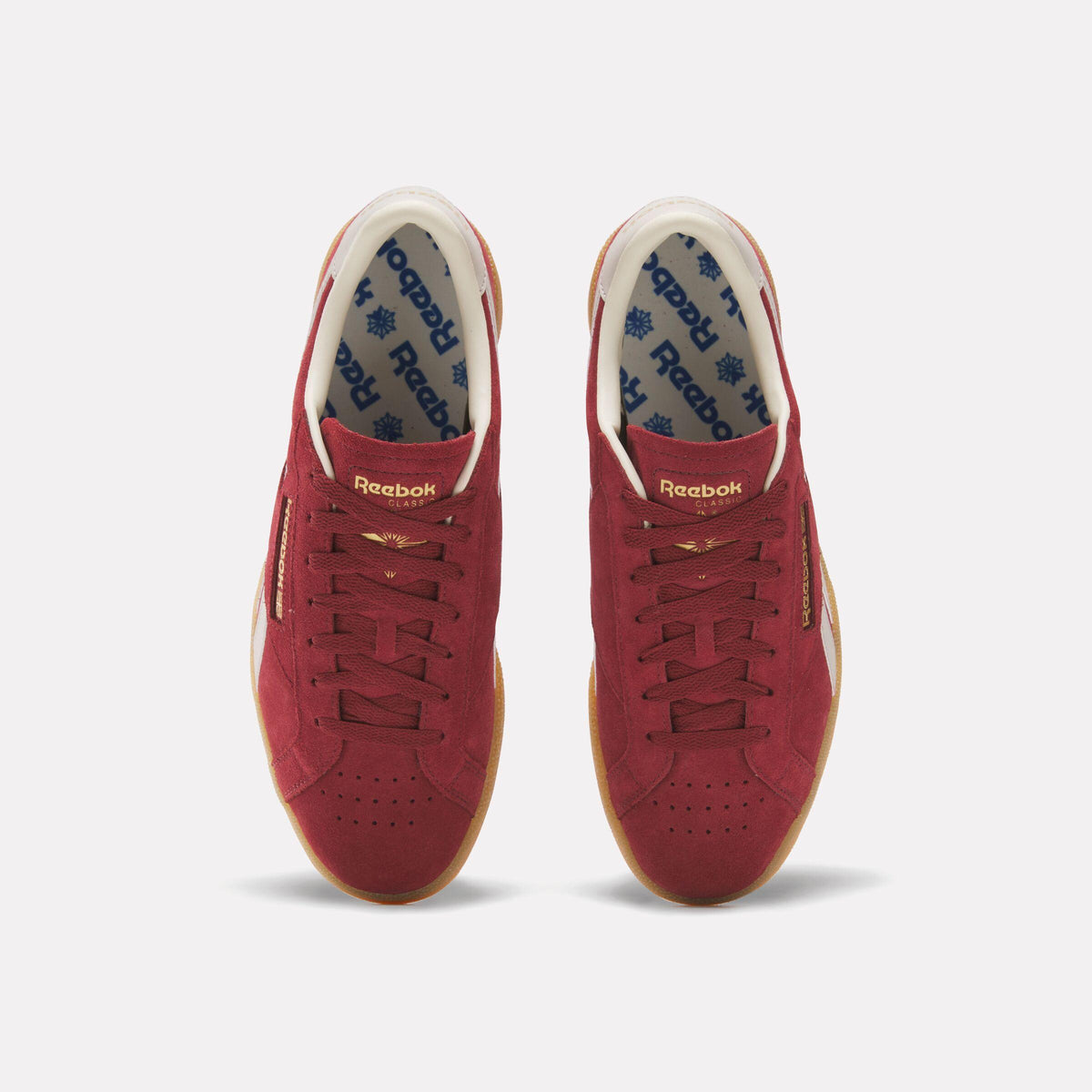 Pair of maroon-suede court sneakers; gum sole, white lining printed with blue logos.