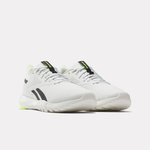 Pair of low-rise white and gray athletic shoes with black stripes and lime green accents.