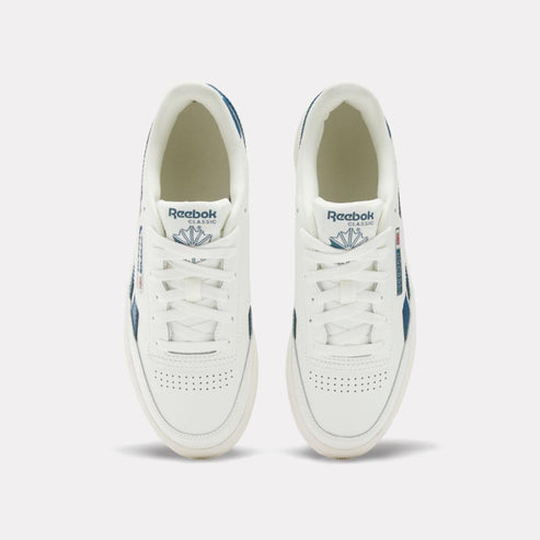 A pair of white sneakers with "Reebok Classic" and the Reebok logo on the tongue.