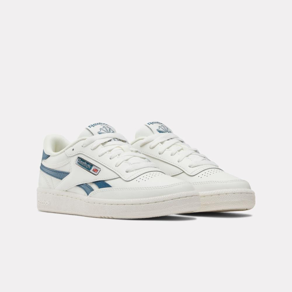 Pair of white low-top sneakers with blue accents.