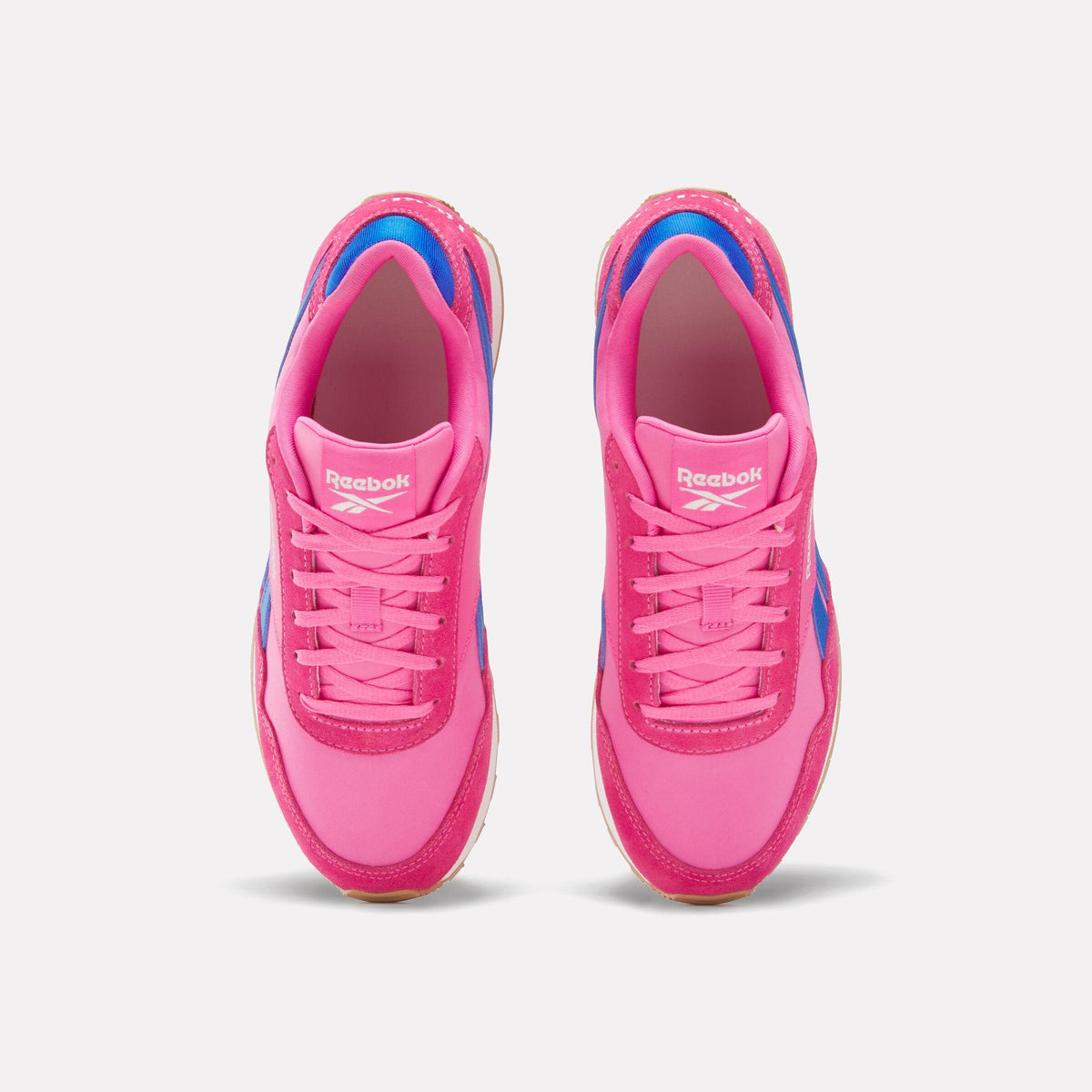 Top-down view of pink sneakers with laces and blue accents.