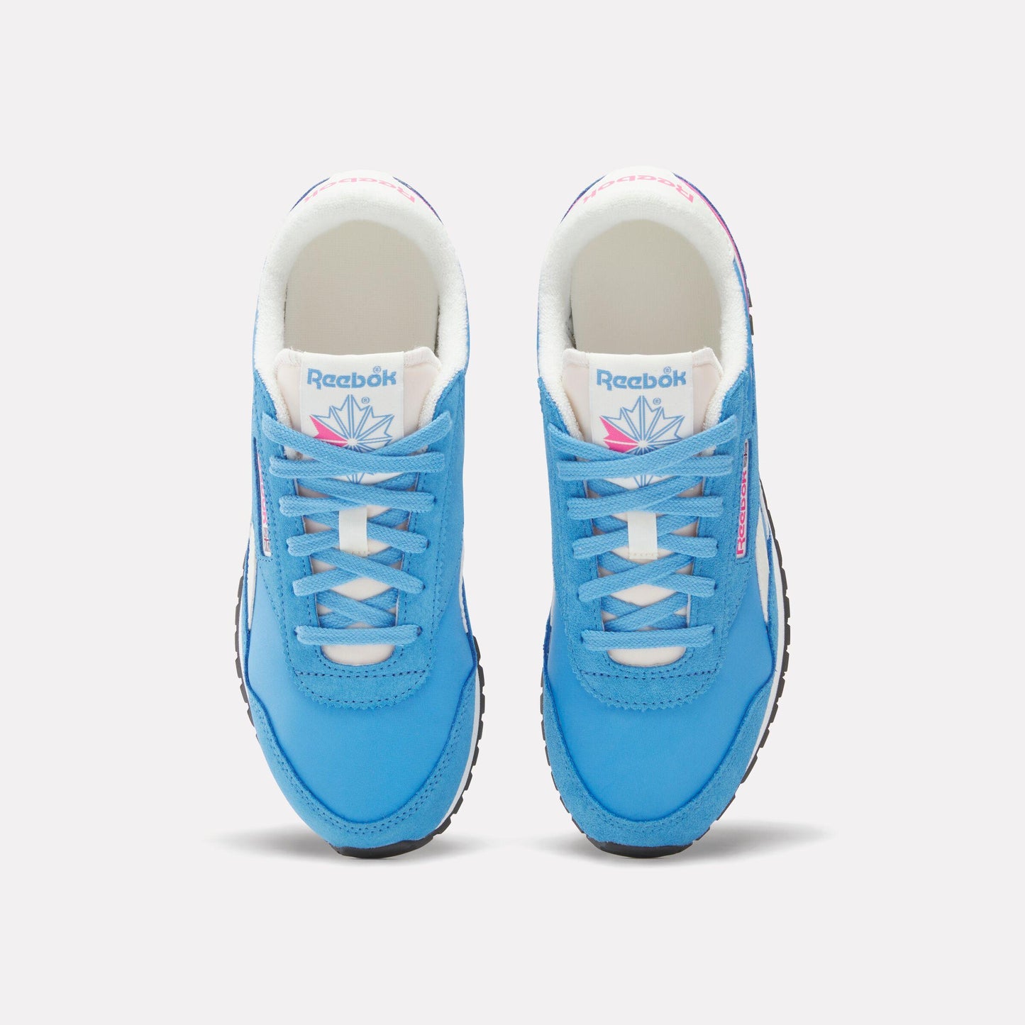 Pair of light blue sneakers, top-down view, white laces, white interior, and black soles.