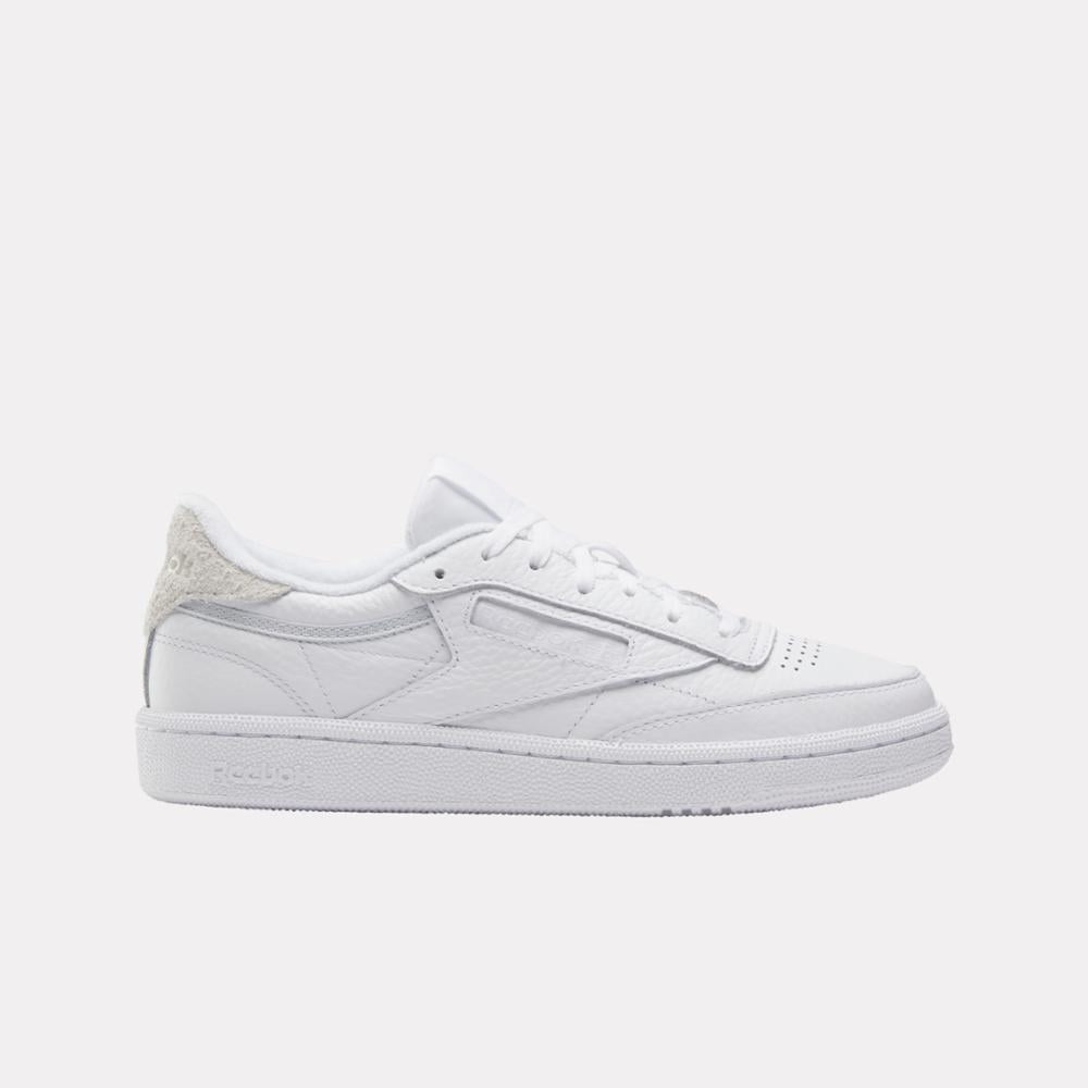 Low-top white sneaker with textured heel.