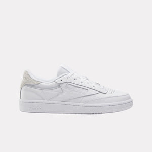 Low-top white sneaker with textured heel.