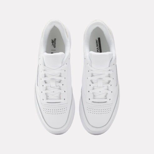 A pair of white leather sneakers with white laces and perforated toe box.