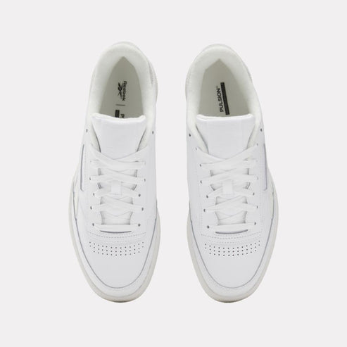 Overhead view of two white sneakers with white laces and perforated toeboxes.