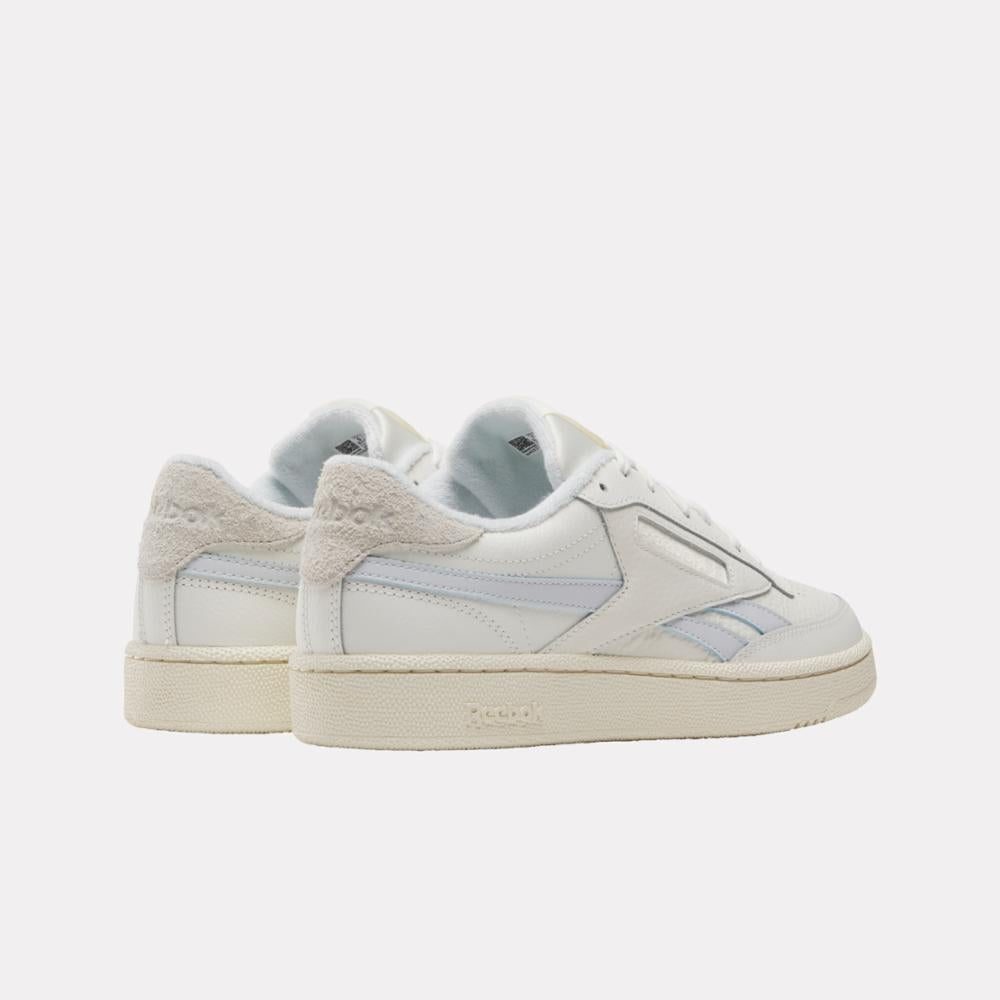 Pair of white sneakers, off-white sole and heel, white upper with light gray accents.