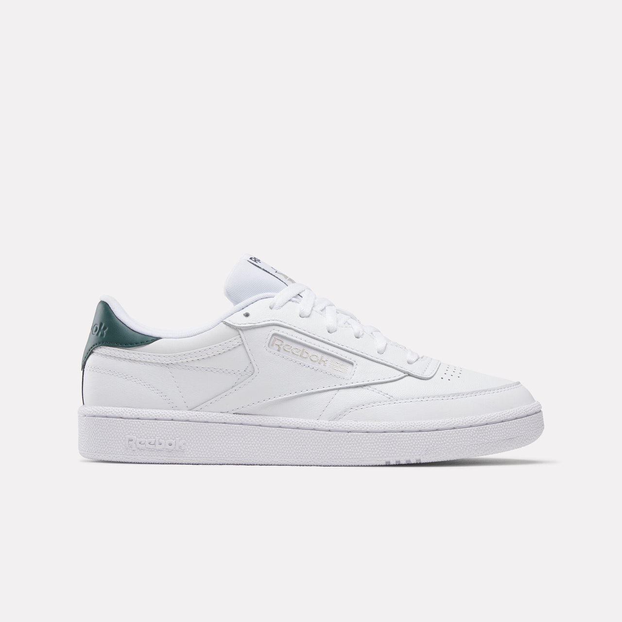 White leather sneaker with green heel counter and white laces.