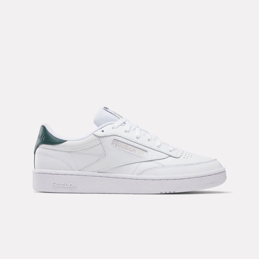 White leather sneaker with green heel counter and white laces.