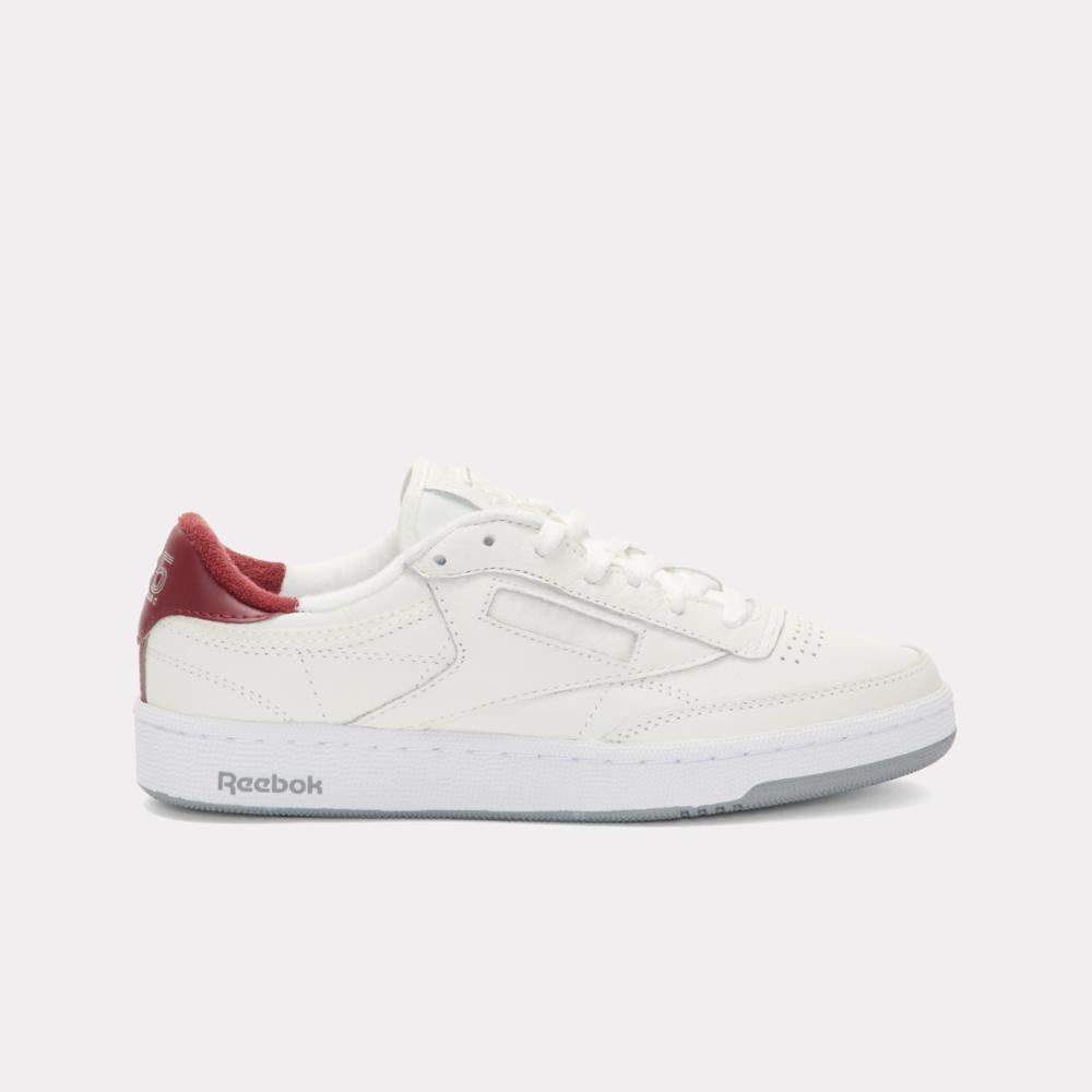 A white leather athletic shoe with a red heel.
