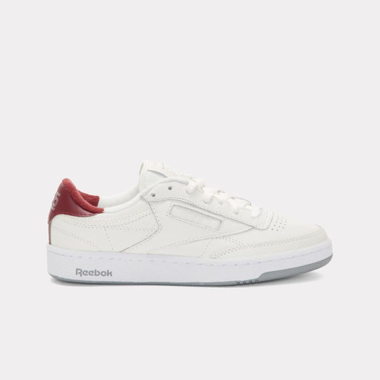 A white leather athletic shoe with a red heel.