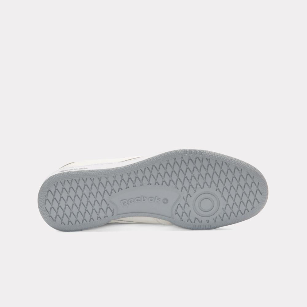 Shoe outsole with gray ripple pattern and 'reebok' text.