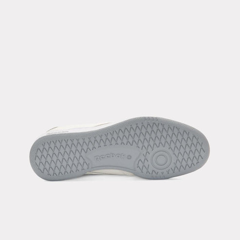 Shoe outsole with gray ripple pattern and 'reebok' text.