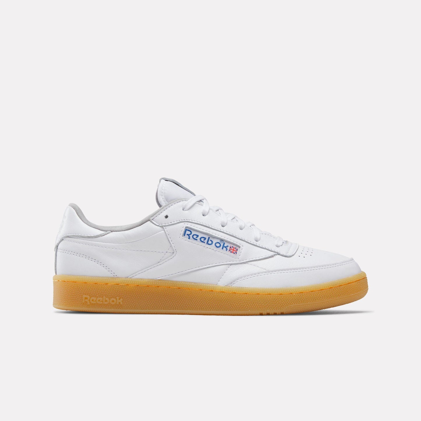 Low-top white leather sneaker with gum sole and blue logo.