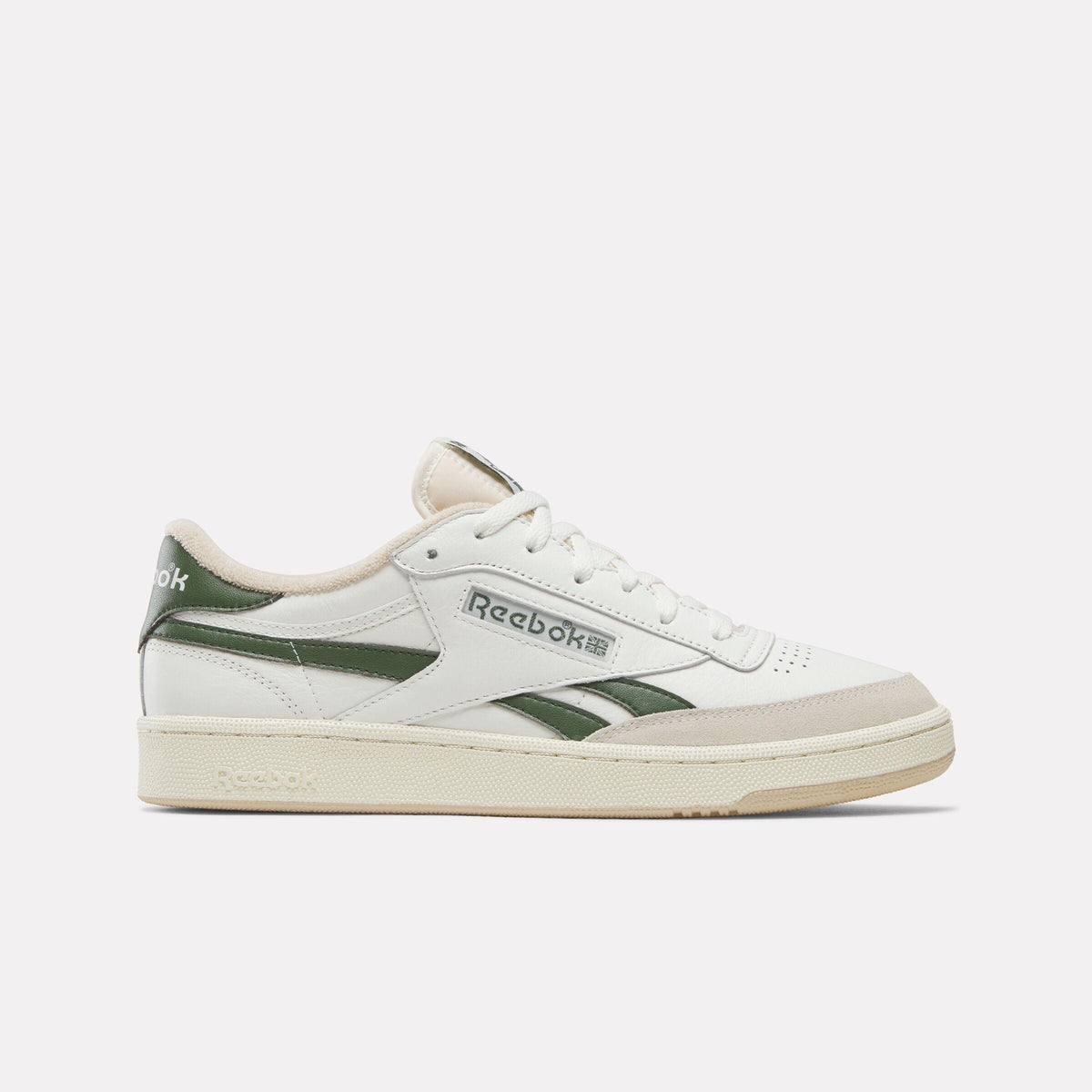 A low-top white sneaker with green stripes and a tan sole.