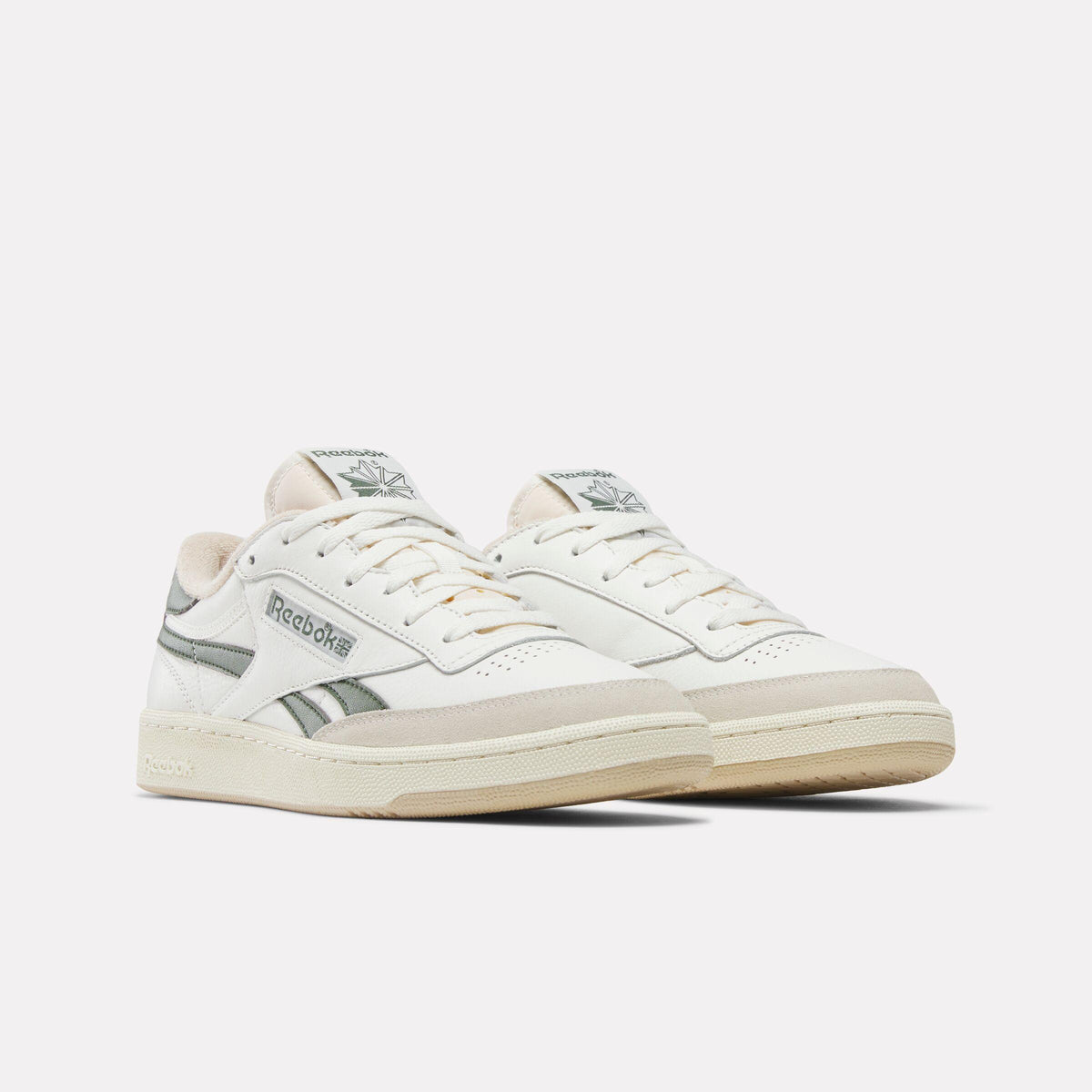 Off-white leather sneakers with gray accents.