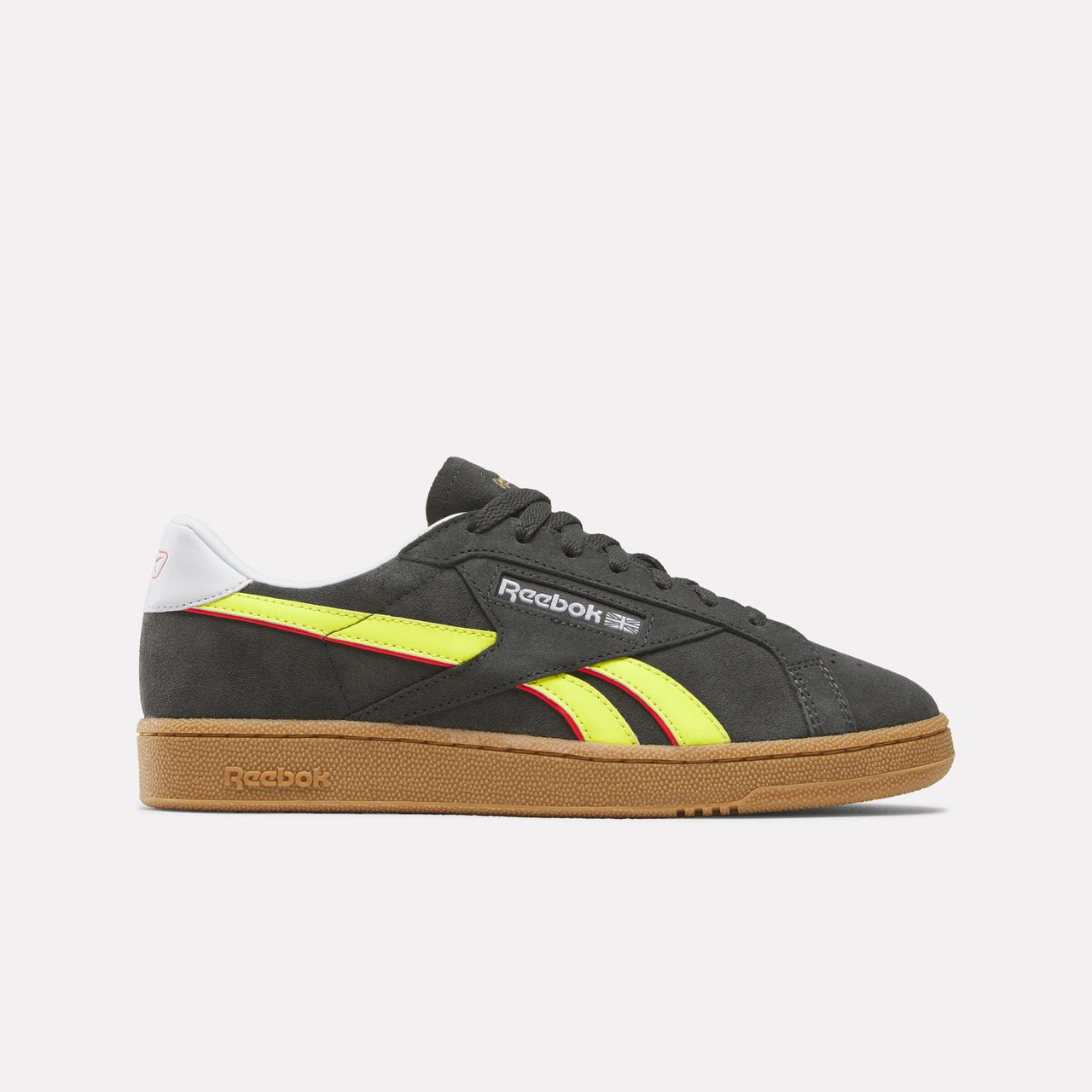 Low top dark gray sneaker with yellow and red stripes, brown sole and white heel.