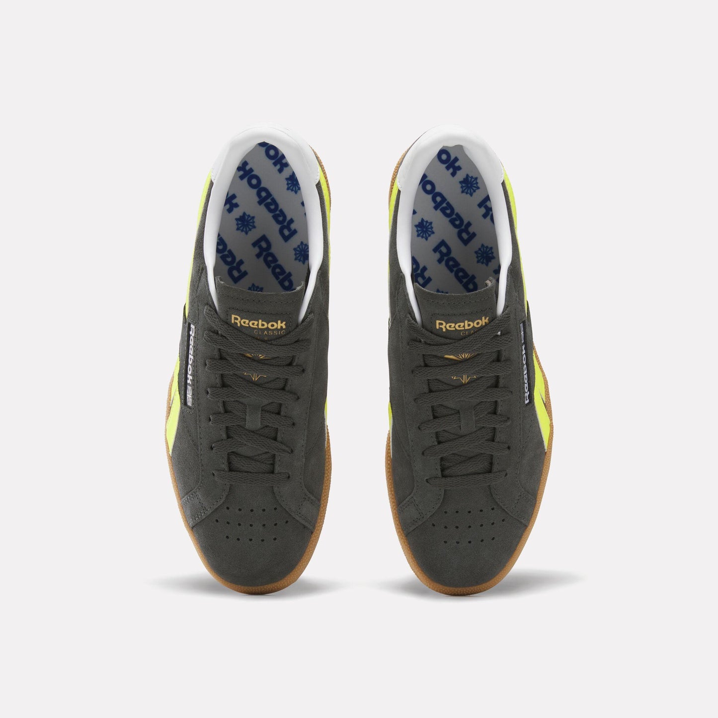 Top-down view of two dark gray sneakers with a white interior lining, blue logo pattern, yellow accents, and brown soles.