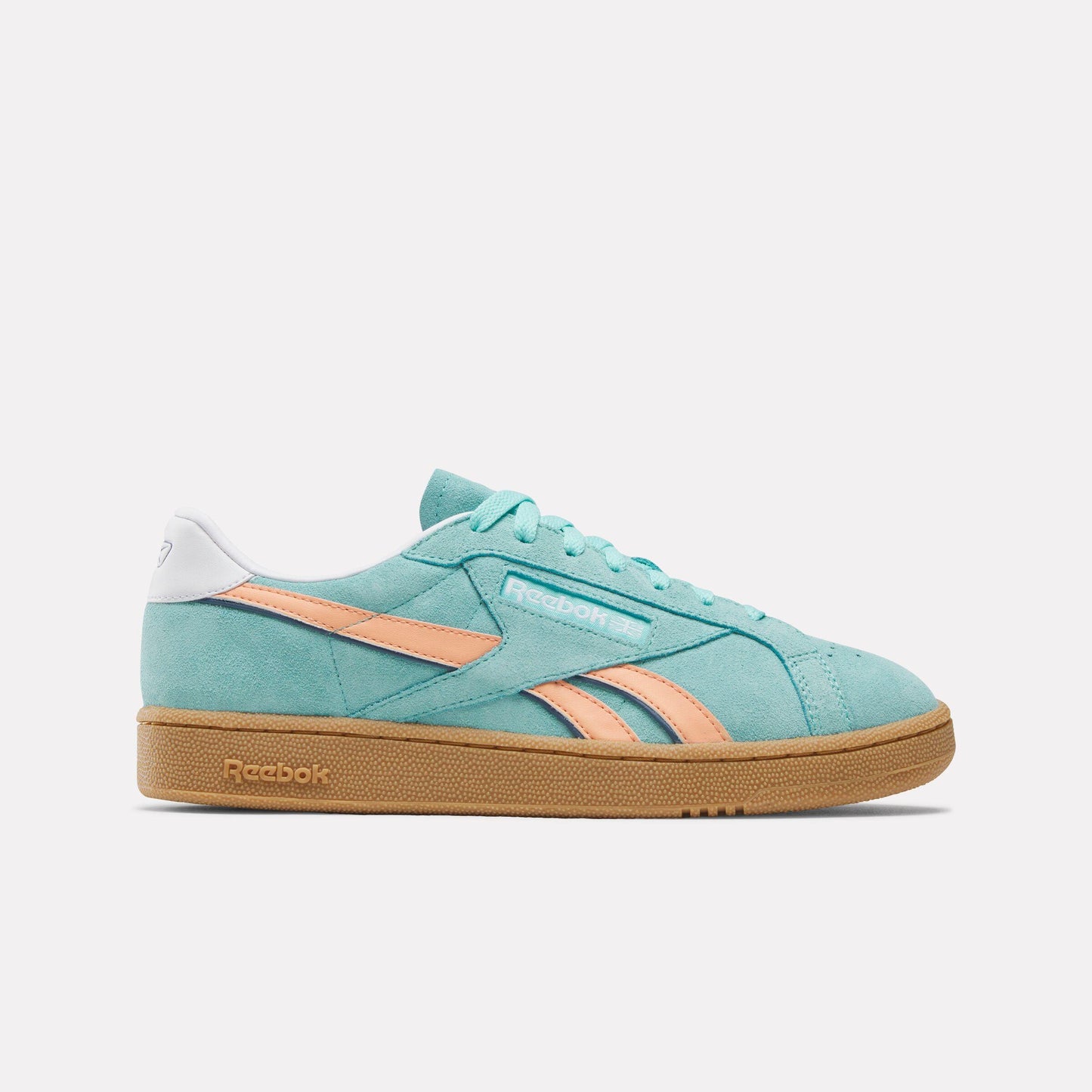 Low top turquoise sneaker with peach stripes and gum sole.