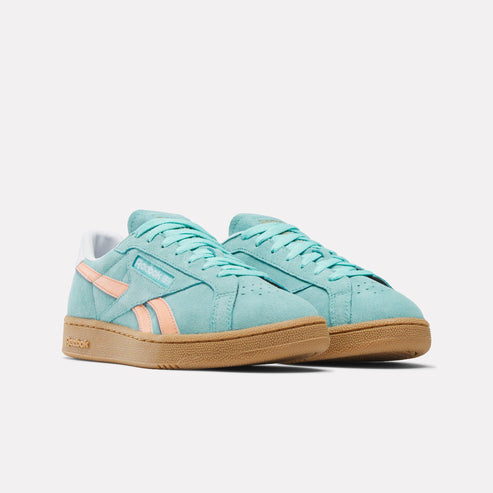 A pair of low-top, light blue suede sneakers with peach stripes and a light brown sole.