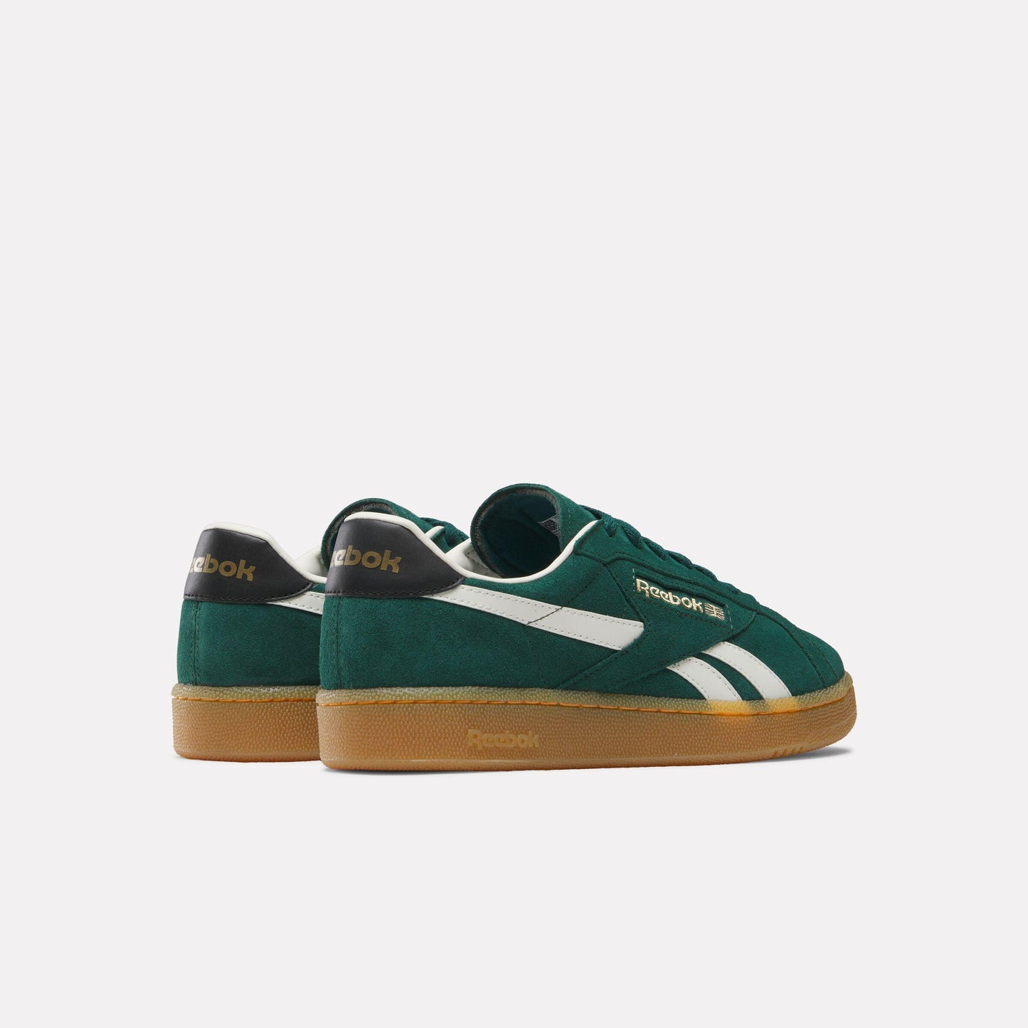 A green sneaker with a gum sole and a white stripe on the side.
