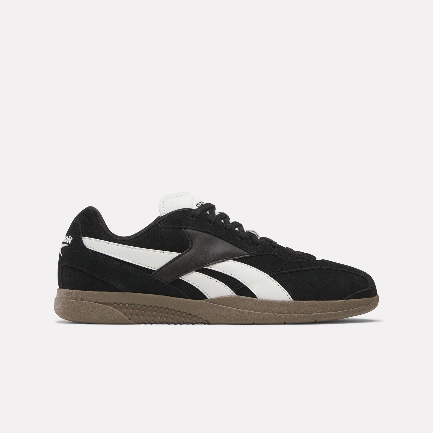 Black low-top sneaker with a white stripe and brown sole.