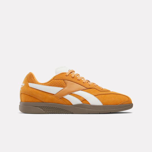 Orange low-top sneaker with white side stripes and brown sole.