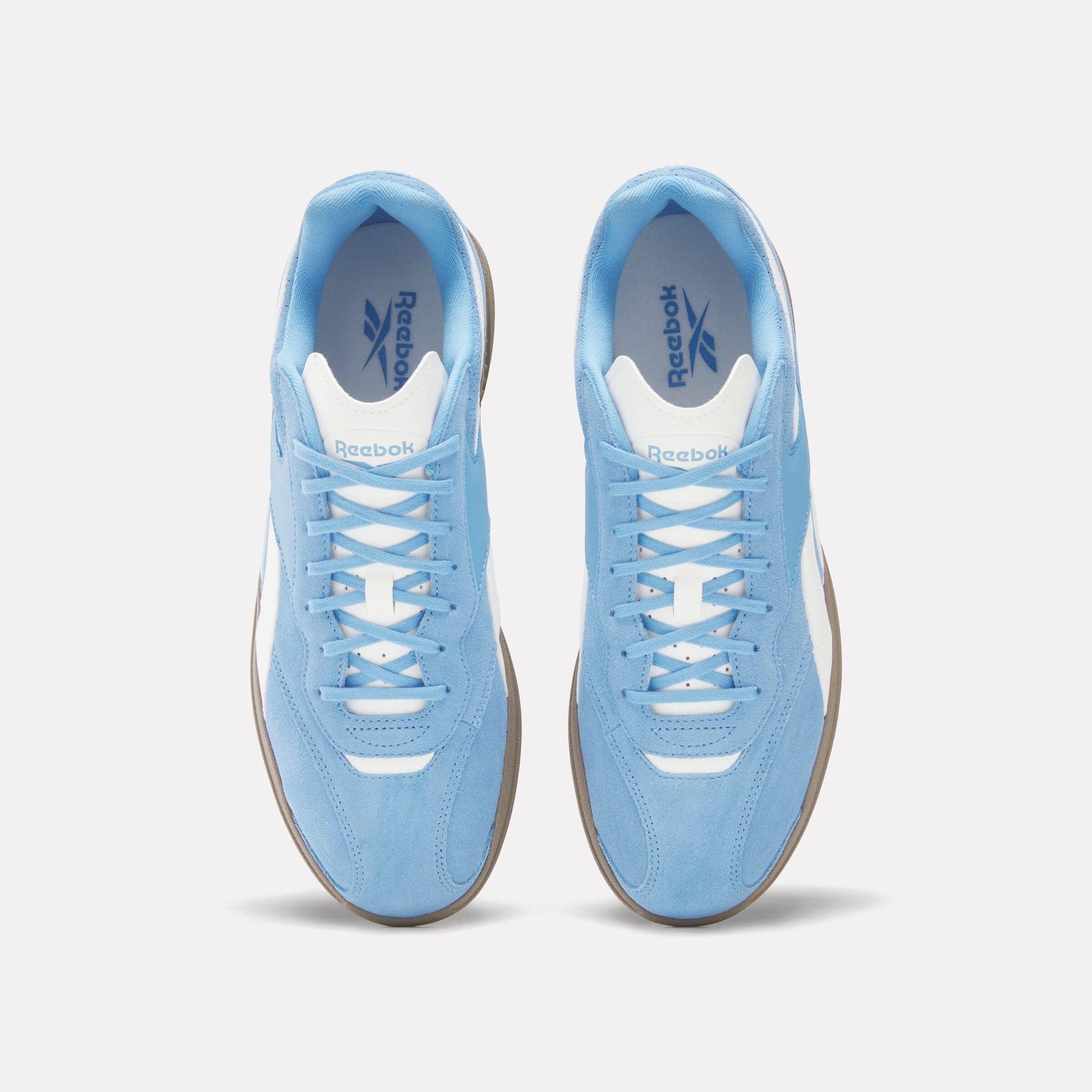 Overhead view of light blue Reebok sneakers with white trim and laces.