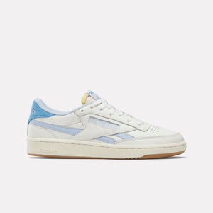 A low-top, off-white sneaker with blue accents, featuring a gum rubber sole.