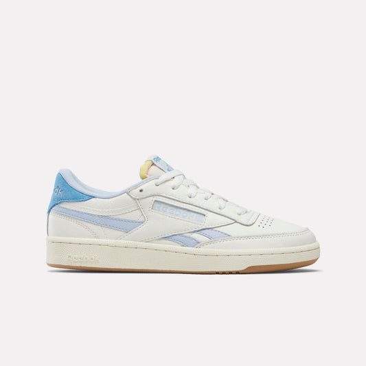 A low-top, off-white sneaker with blue accents, featuring a gum rubber sole.