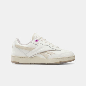 Off-white low-top sneaker with white laces and a pink accent near the tongue.